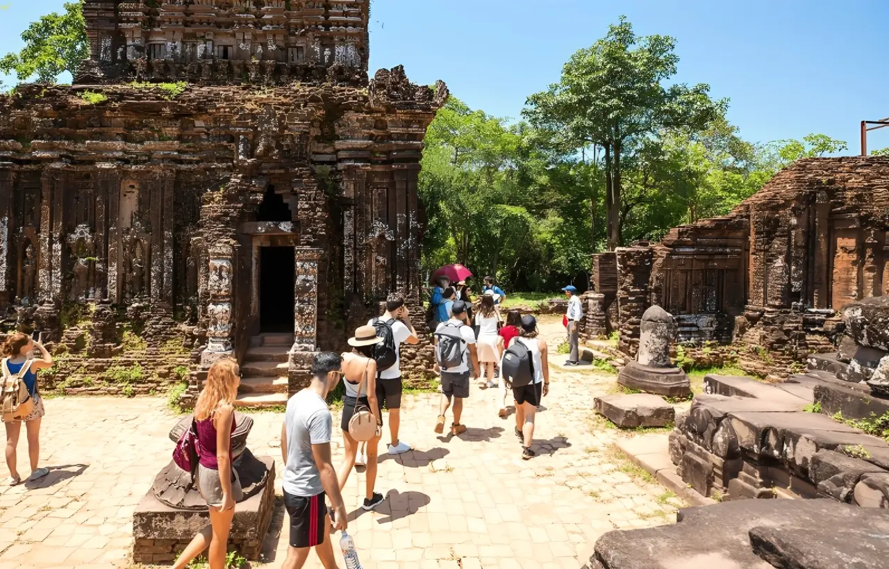 Visitors exploring My Son Holyland ancient Champa temples during sunset with guided cultural experience