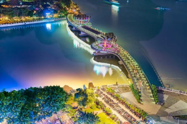 Can Tho pedestrian bridge illuminated at night over Hau River, showcasing modern architecture and vibrant city lights in Can Tho, Vietnam