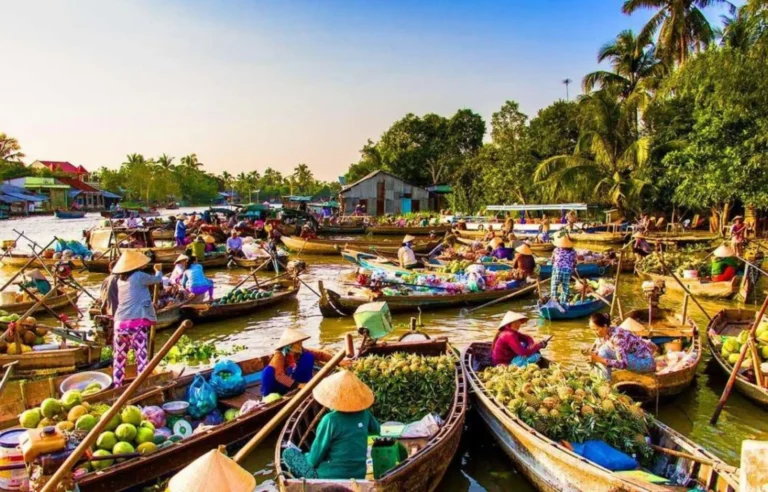 Traditional floating market with local boats and fresh fruits in Mekong Delta, Vietnam travel