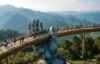 Visitors walking on Golden Bridge held by giant stone hands at Ba Na Hills, Da Nang, Vietnam