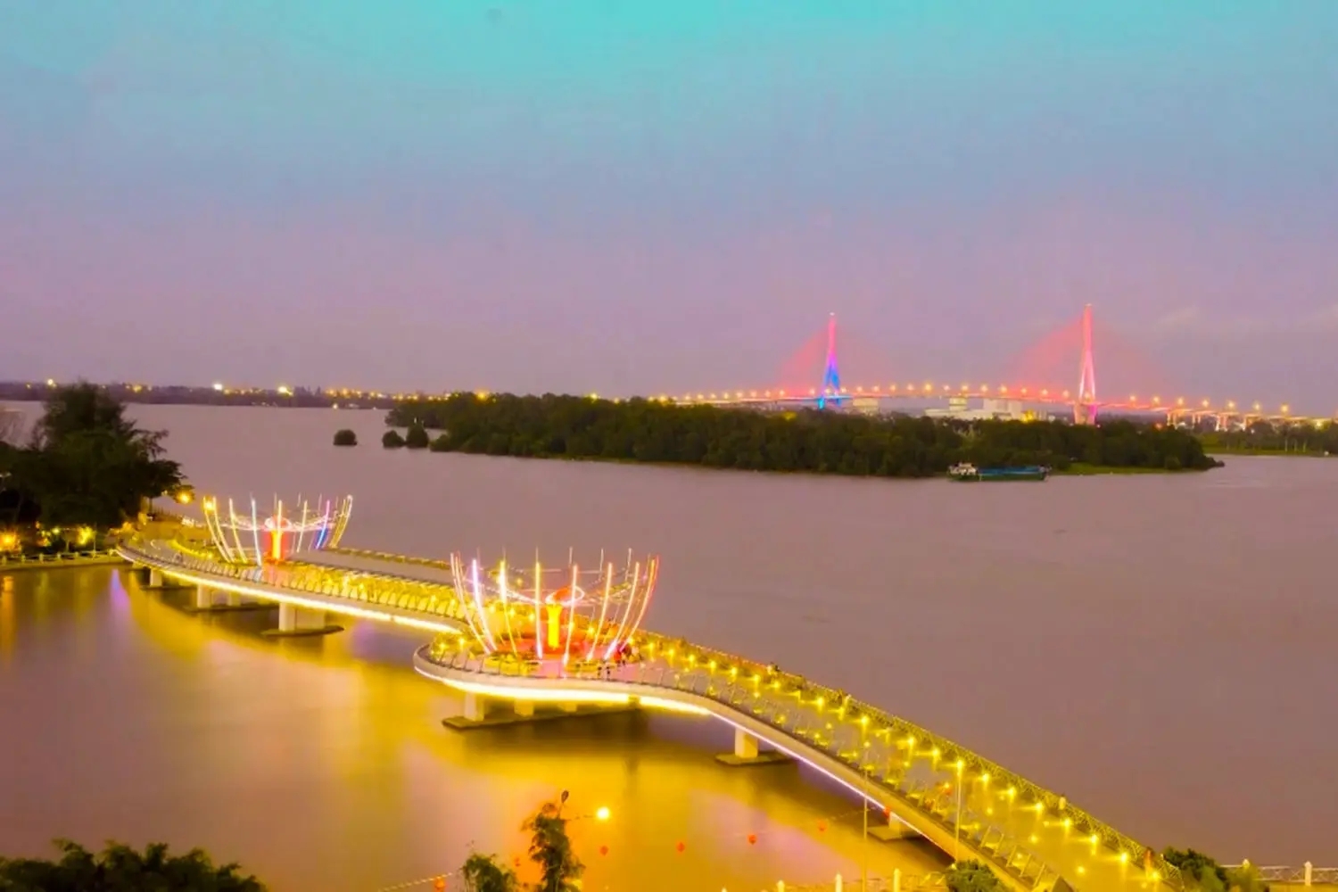 Ninh Kieu Wharf in Can Tho with riverside promenade, boats on the Hau River, and city skyline in the Mekong Delta