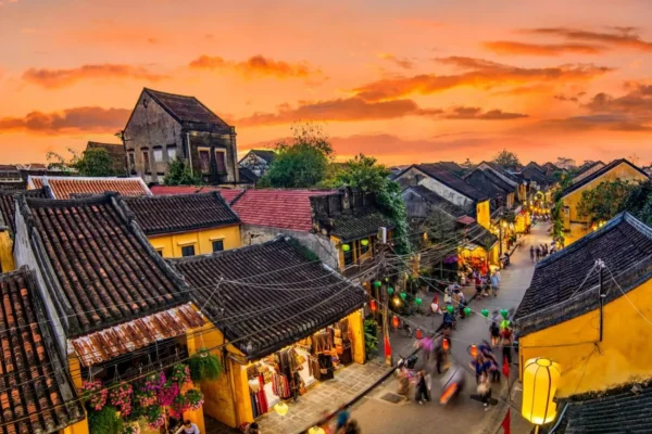 Traditional ancient house in Hoi An Ancient Town with yellow walls, wooden doors, tiled roof, and preserved heritage architecture