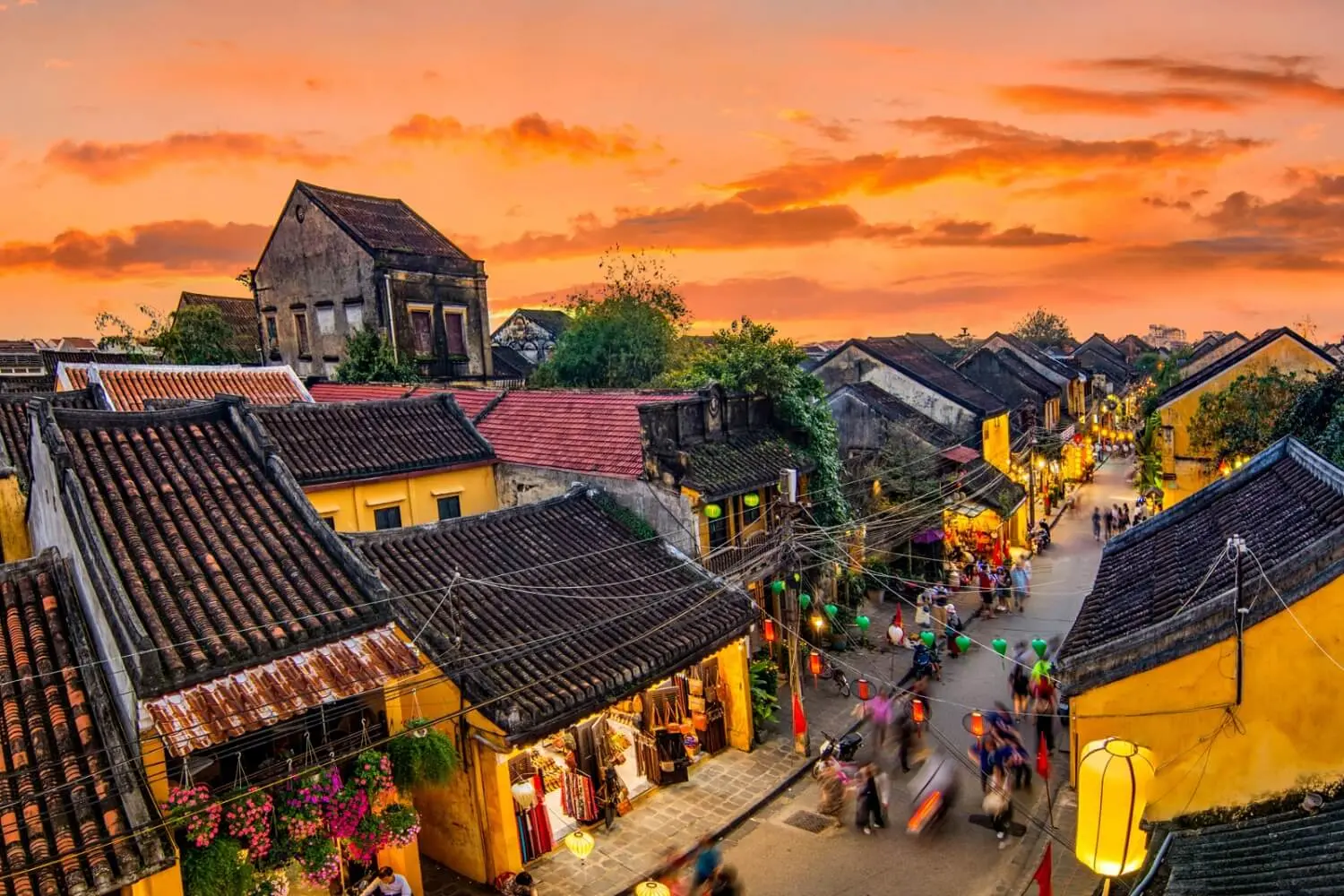 Traditional ancient house in Hoi An Ancient Town with yellow walls, wooden doors, tiled roof, and preserved heritage architecture