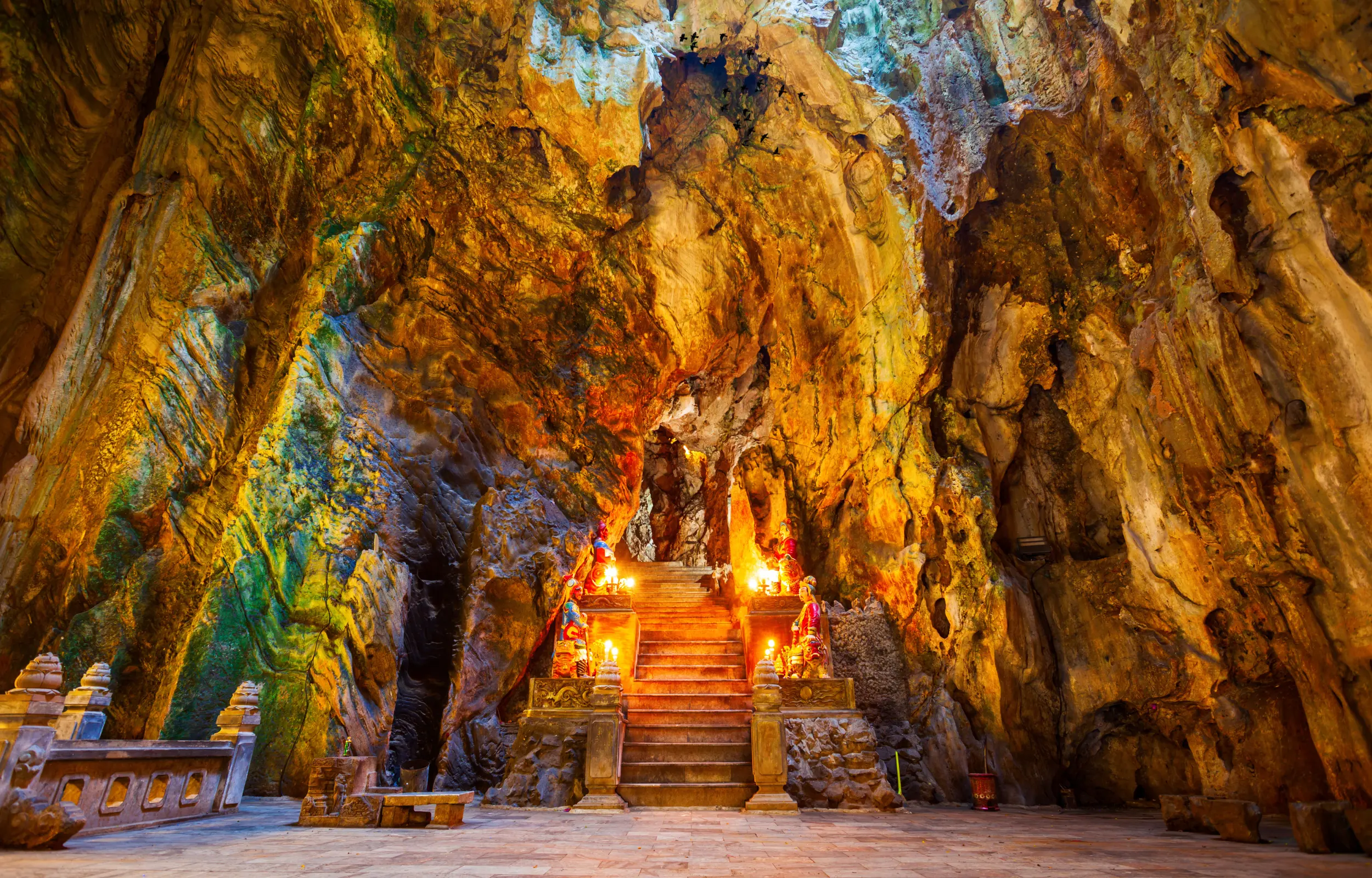 Interior of Am Phu Cave in Marble Mountains, Da Nang, featuring dramatic rock formations, Buddhist statues, and mystical lighting