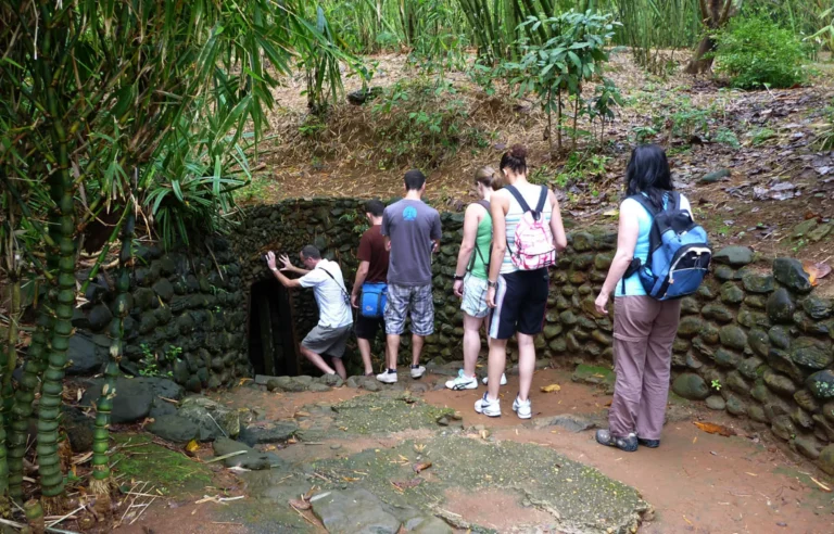 International travelers exploring the Cu Chi Tunnels historical site near Ho Chi Minh City Vietnam travel