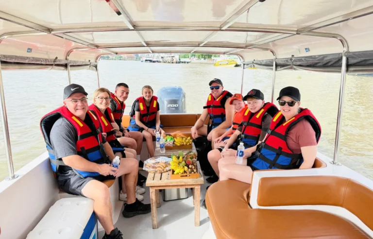 International travelers on a river boat tour to Cu Chi Tunnels near Ho Chi Minh City Vietnam travel