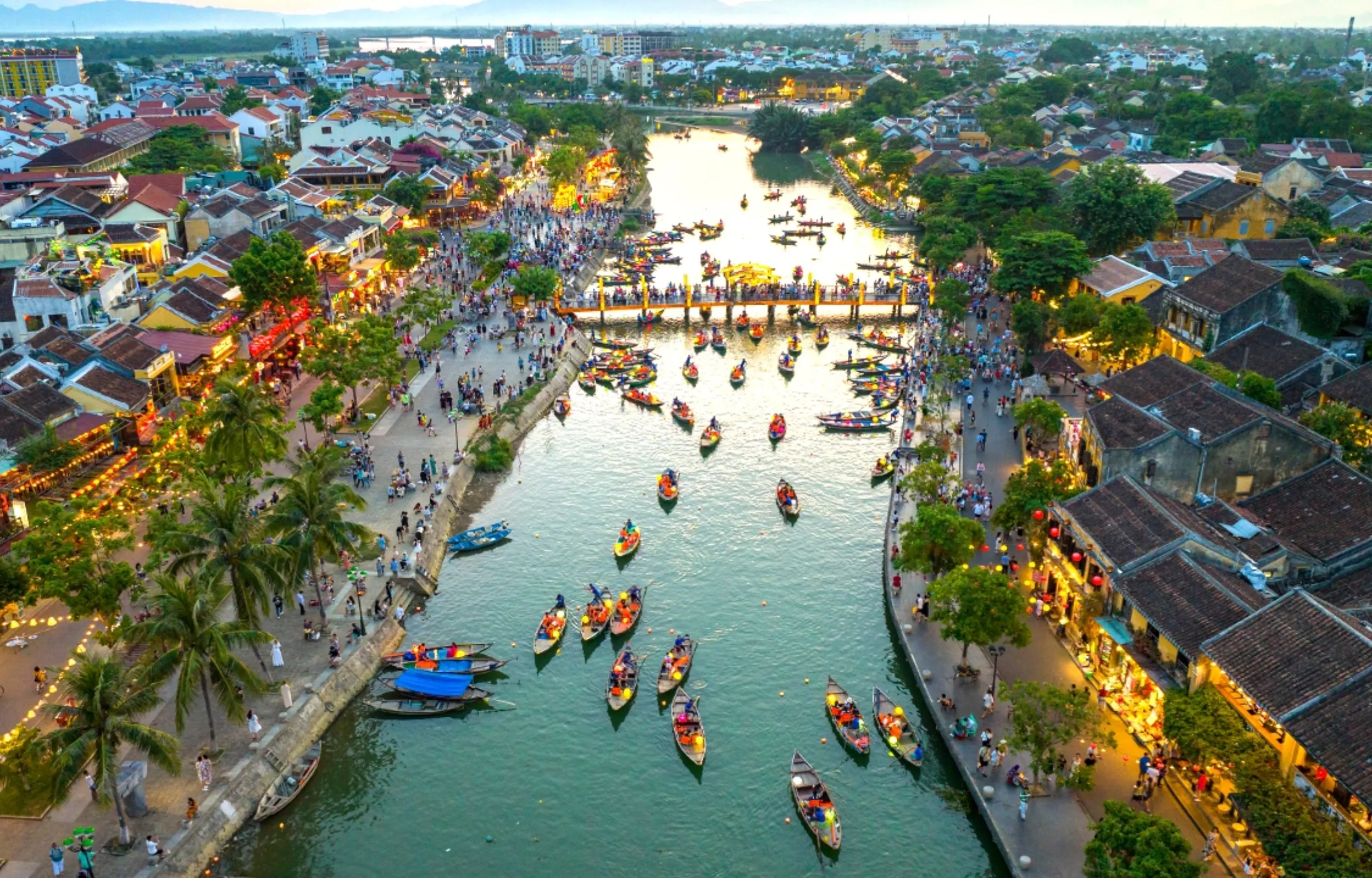 Aerial view of Hoi An ancient town with boats on the river and lantern streets Vietnam travel