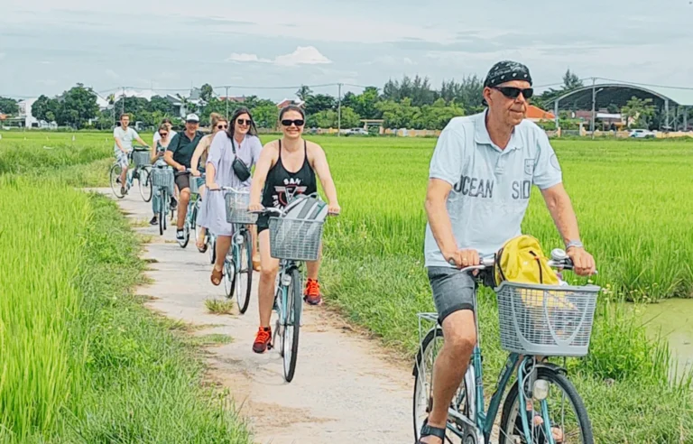 Cycling through rice fields on a farming and fishing life by bike tour in Hoi An Vietnam travel