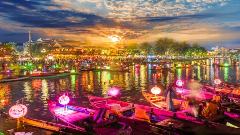 Hoi An ancient town at sunset with colorful lantern boats on the river Vietnam travel