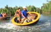 Tourists enjoying Mekong basket boat spinning experience through coconut forest canals in Vietnam