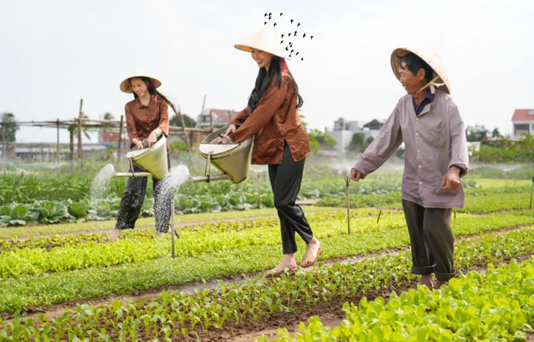 Tourists experiencing traditional farming activities at Tra Que Vegetable Village in Hoi An, Vietnam, learning to be a real farmer