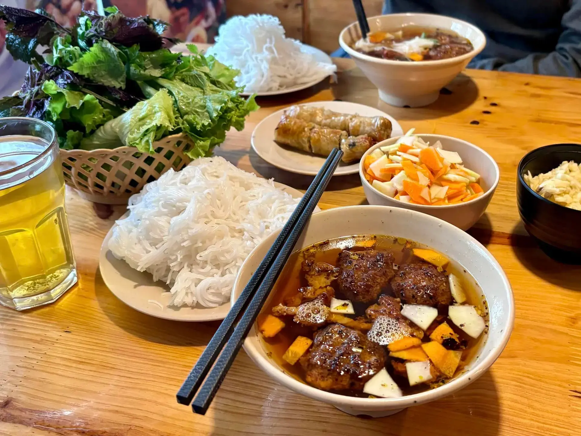 Bun Cha Hanoi with grilled pork, rice noodles and fresh herbs served in traditional dipping sauce