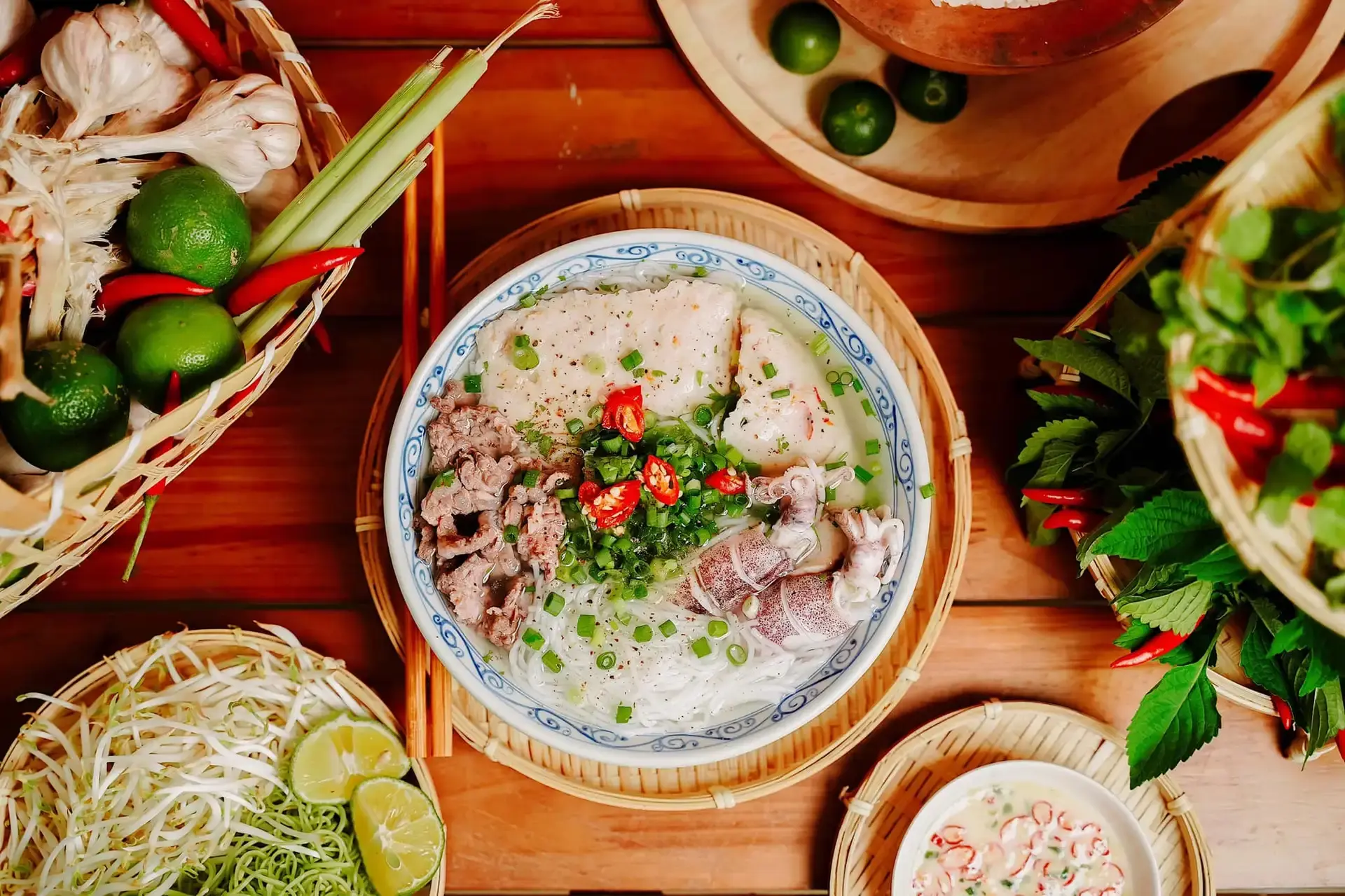 Bowl of Bun Quay Phu Quoc with fresh shrimp and fish paste, clear broth, herbs, and chili, famous local food in Phu Quoc Vietnam