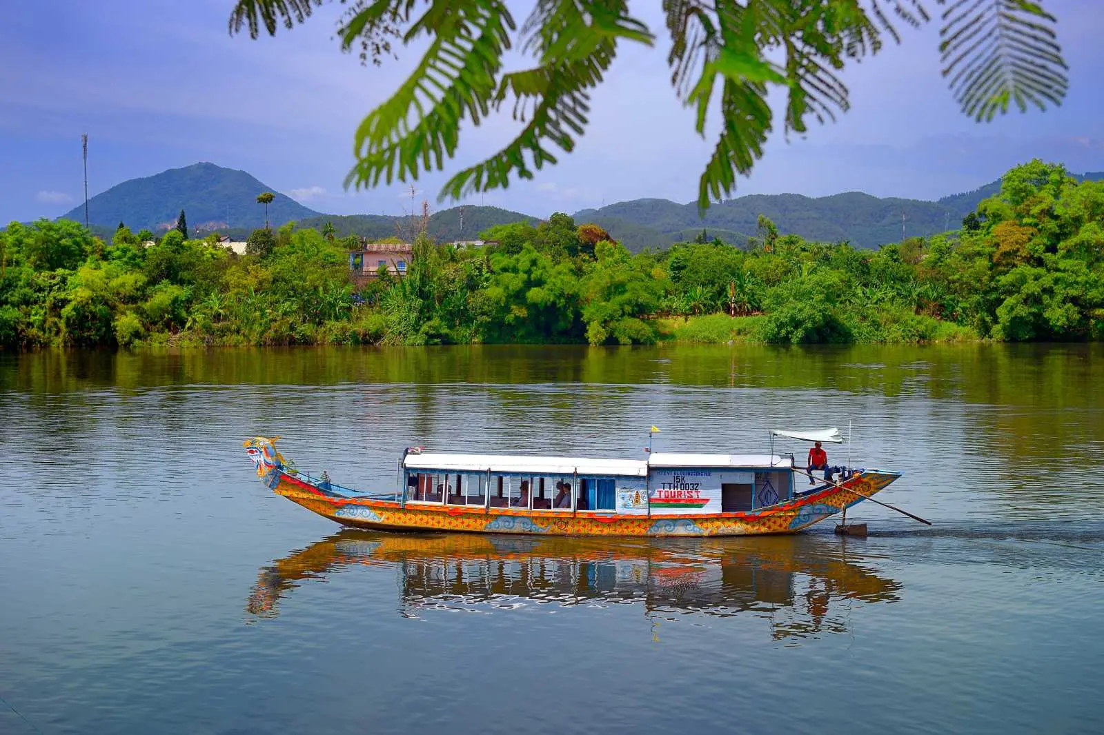 Dragon boat cruise on Perfume River in Hue with sunset scenery and traditional music
