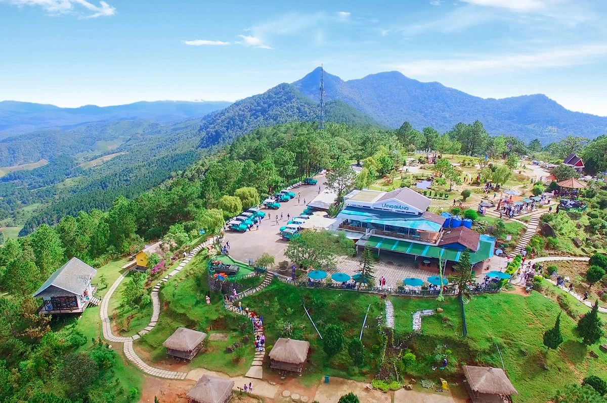 Scenic view from Langbiang Mountain overlooking pine forests and rolling hills in Da Lat.