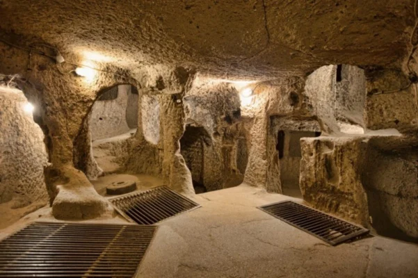 Interior of an underground chamber inside the Cu Chi Tunnels with carved walls and small passageways.