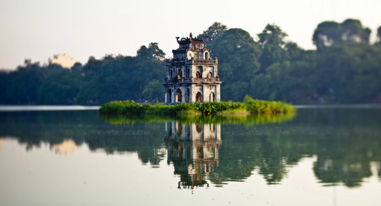 Turtle Tower reflected in the calm waters of Hoan Kiem Lake in Hanoi.