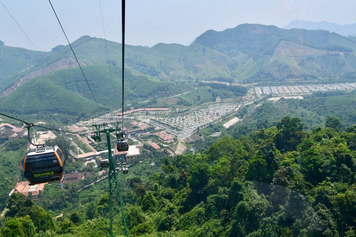 Cable cars traveling above lush mountains at Ba Na Hills Cable Car.