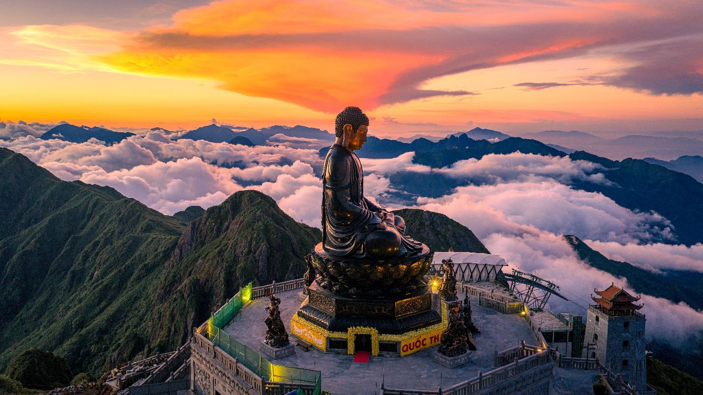 Giant Buddha statue at Fansipan surrounded by mountains and clouds in Sapa.