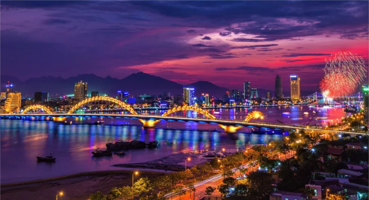 Dragon Bridge illuminated at night with fireworks over Da Nang city.