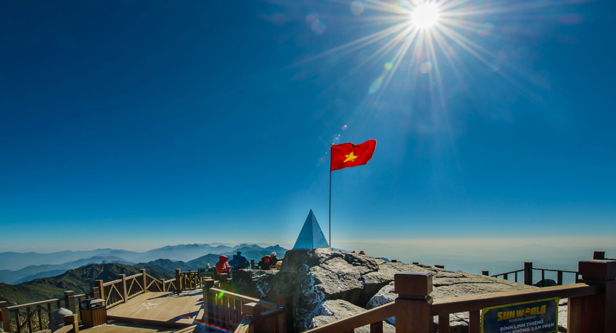 Panoramic view from Fansipan Peak with mountains, clouds, and lush green valleys in Sapa, Vietnam