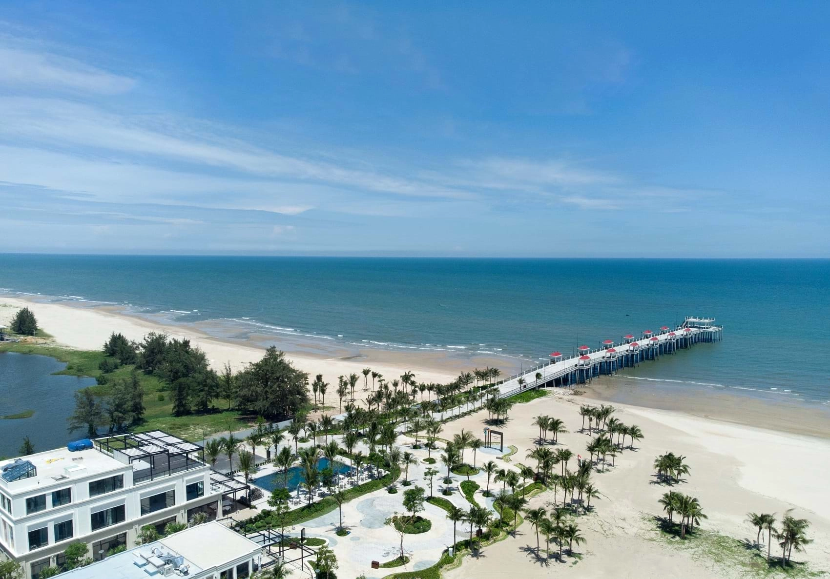 Ho Tram beach with a long wooden pier and palm-lined resort coastline in Ba Ria Vung Tau Vietnam