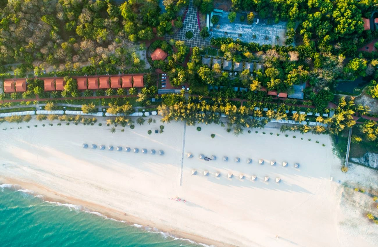 Aerial view of Ho Coc beach resort coastline with white sand beach and tropical trees in Vietnam