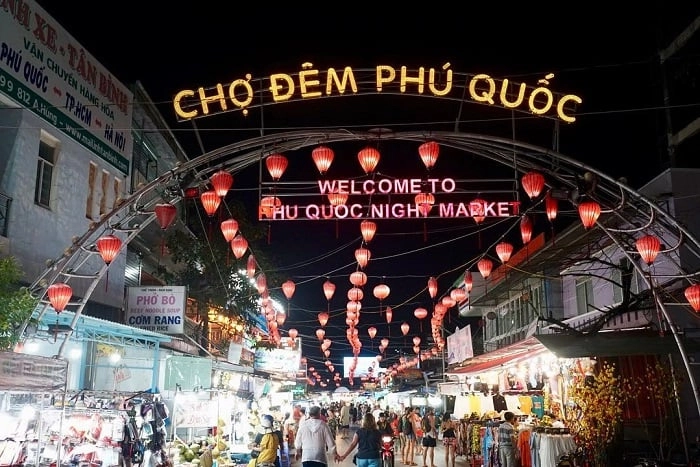 Entrance gate of Phu Quoc Night Market illuminated with lanterns and street food stalls at night