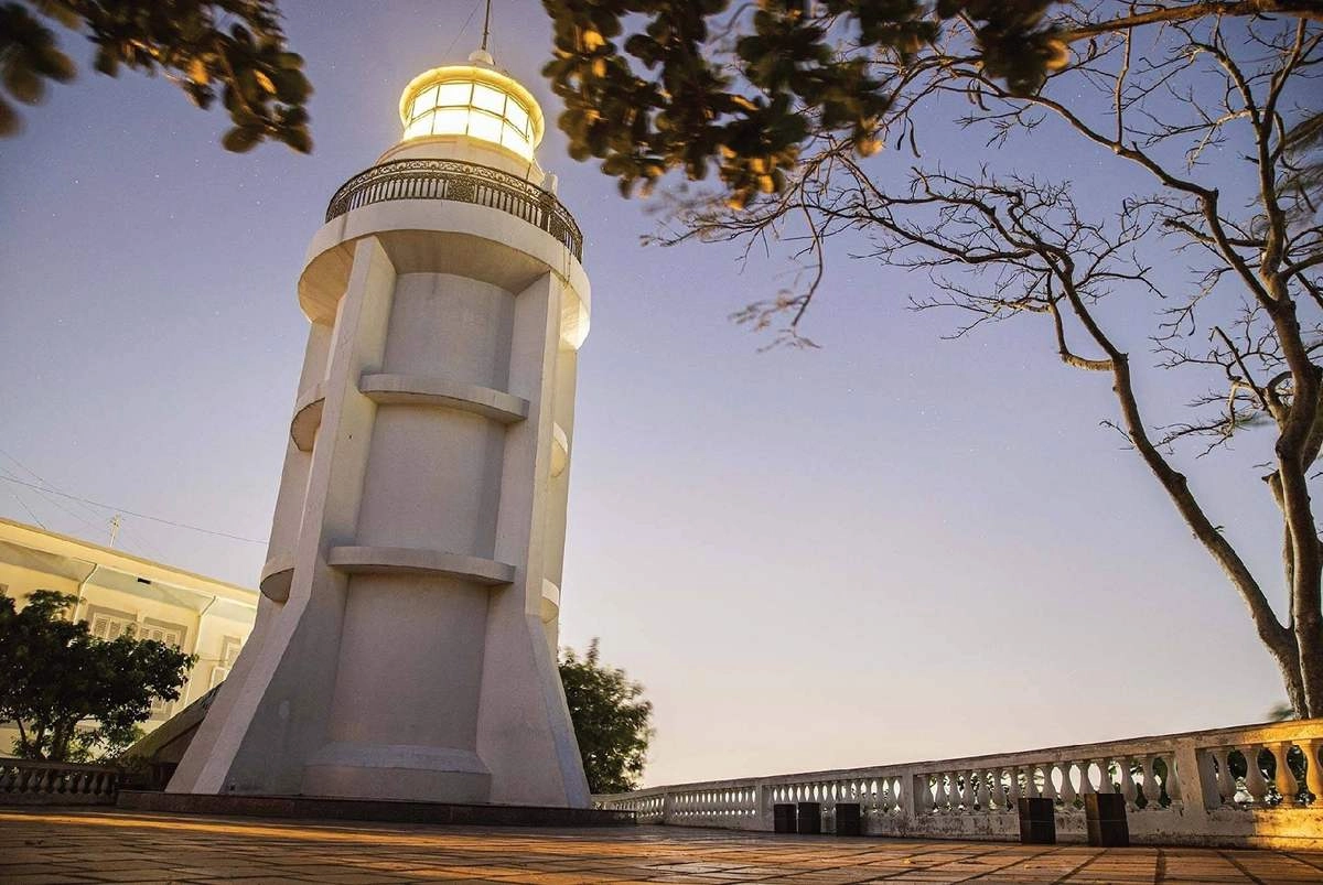 Vung Tau Lighthouse historic landmark overlooking the coastal city of Vung Tau Vietnam at sunset