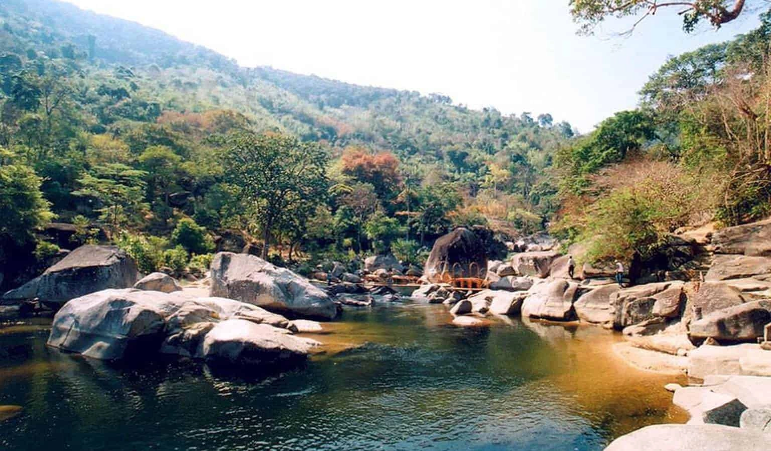 Rocky river landscape surrounded by tropical forest in Yok Don National Park.
