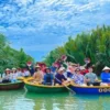 Group of travelers enjoying basket boat rides in Bay Mau Coconut Forest surrounded by lush nipa palms in Hoi An with StarTour