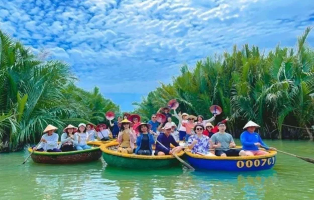 Group of travelers enjoying basket boat rides in Bay Mau Coconut Forest surrounded by lush nipa palms in Hoi An with StarTour