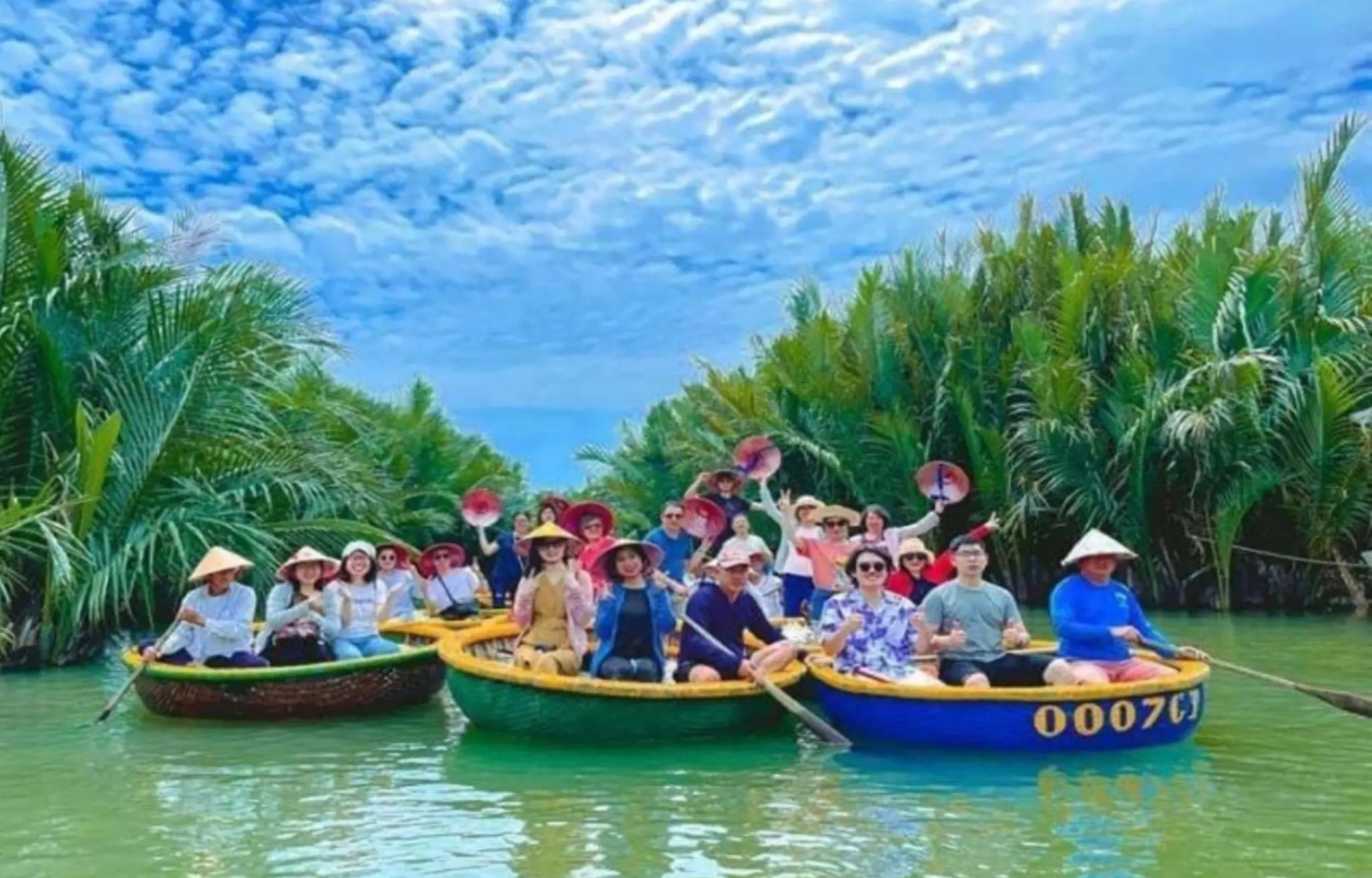 Group of travelers enjoying basket boat rides in Bay Mau Coconut Forest surrounded by lush nipa palms in Hoi An with StarTour