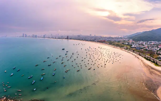 Aerial view of My Khe Beach in Da Nang with fishing boats, coastline and sunset sky in Vietnam by Star Tour.