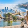 Travel collage of Vietnam featuring Dragon Bridge in Da Nang, Hoan Kiem Lake in Hanoi, Golden Bridge at Ba Na Hills, Hoi An Ancient Town, and a traveler with suitcase with StarTour