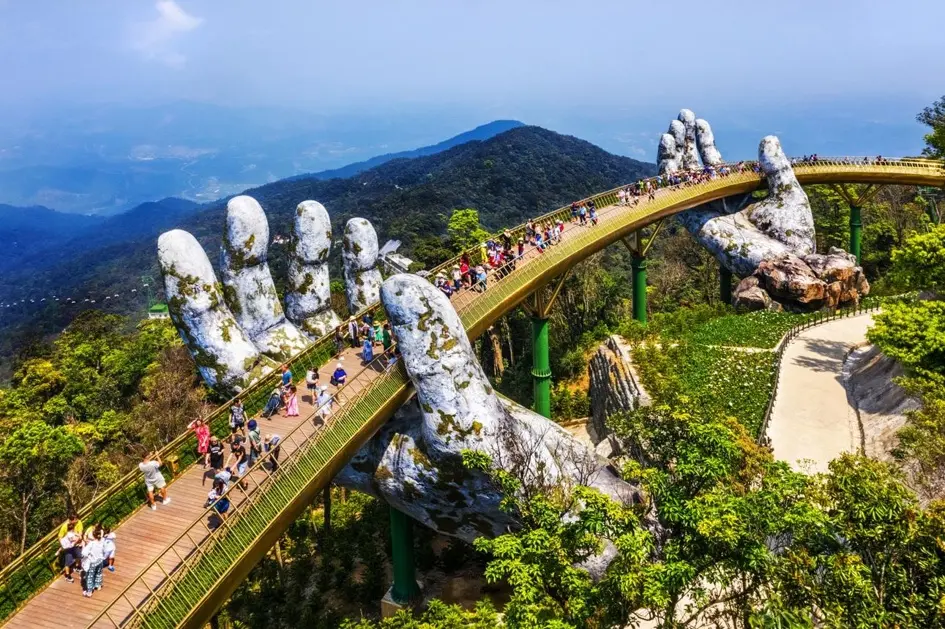 Da Nang travel attraction featuring the famous Golden Bridge held by two giant hands at Ba Na Hills resort
