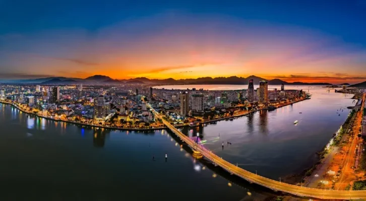 Da Nang travel experience with a breathtaking panoramic night view of Han River Bridge and the illuminated city skyline