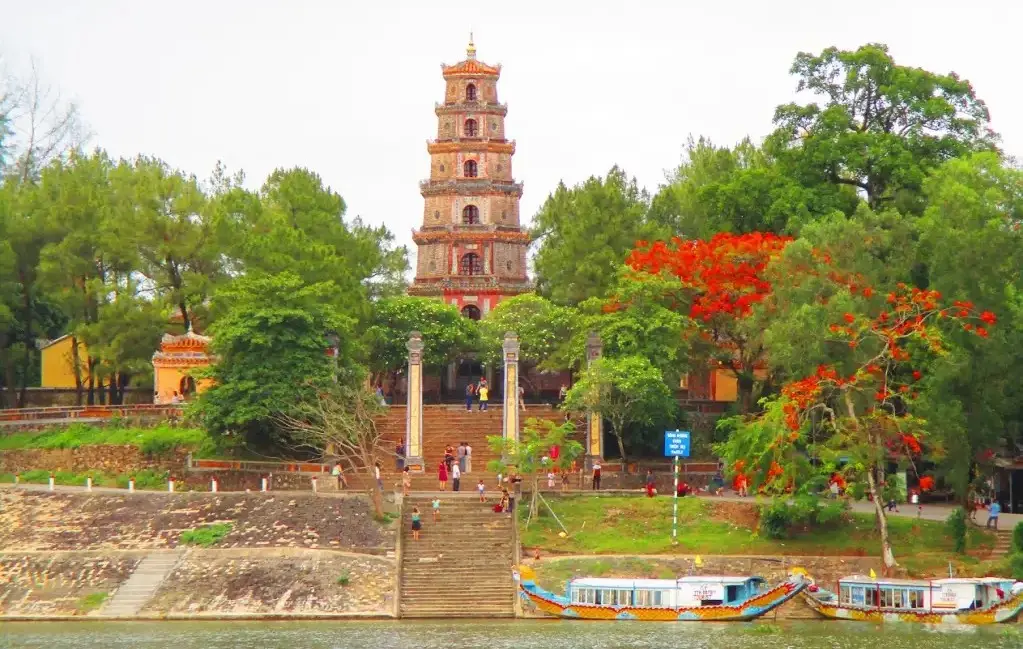 Thien Mu Pagoda and dragon boats on Perfume River near Hue Imperial Citadel on a guided tour with startour.