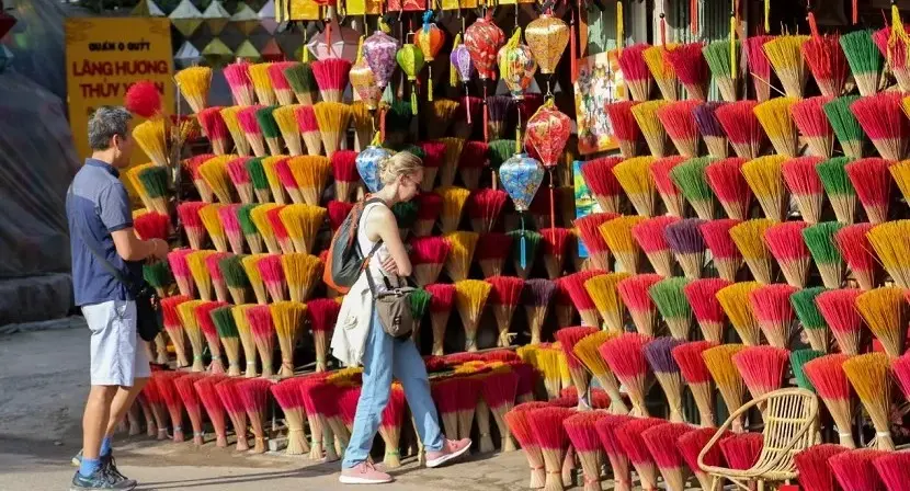 Foreign tourists admiring colorful incense bundles at Thuy Xuan Incense Village near Hue Imperial Citadel on a tour with startour.